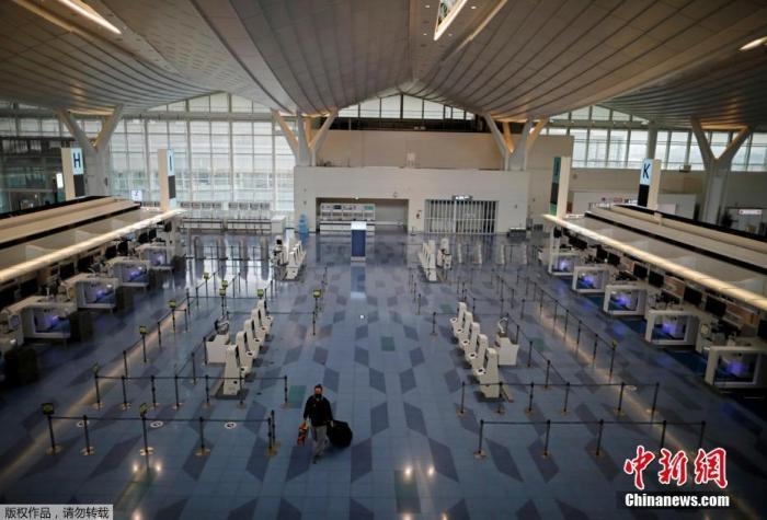 資料圖：日本東京，東京國際機場，一名乘客在國際航班航站樓的登機區(qū)。