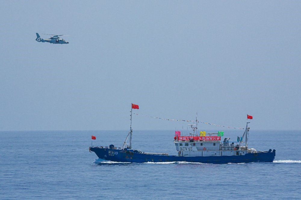 ↑中國(guó)海軍第40批護(hù)航編隊(duì)中的艦載直升機(jī)在被護(hù)船只周邊海域巡邏警戒（2022年6月4日攝）。新華社發(fā)（唐文 攝）