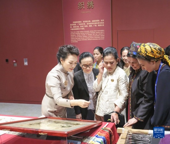  10月18日上午，國家主席習近平夫人彭麗媛邀請出席第三屆“一帶一路”國際合作高峰論壇的外方領導人夫人參觀中國工藝美術館（中國非物質文化遺產館）。這是彭麗媛同外方領導人夫人觀看刺繡。新華社記者 殷博古 攝