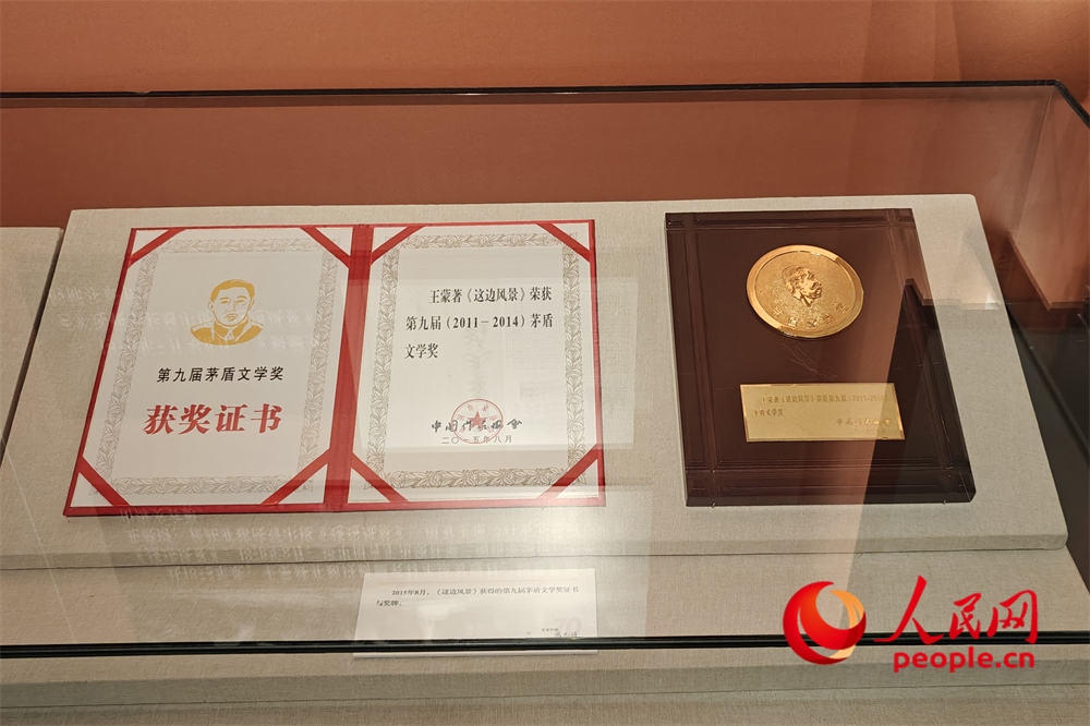 《這邊風景》獲得的第九屆茅盾文學獎證書與獎牌。人民網(wǎng)記者 韋衍行攝