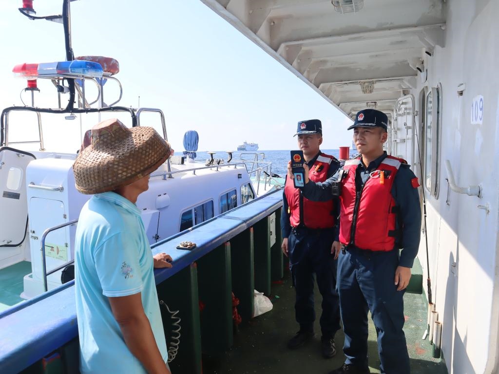 圖為5月12日海警執(zhí)法員登臨檢查漁船。（中國(guó)海警局南海分局供圖）