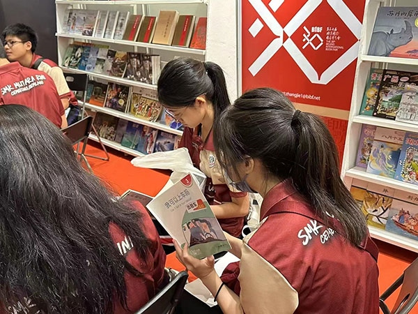 馬來西亞讀者在中國聯(lián)合展臺翻閱中國書籍。 中國圖書進出口（集團）有限公司供圖