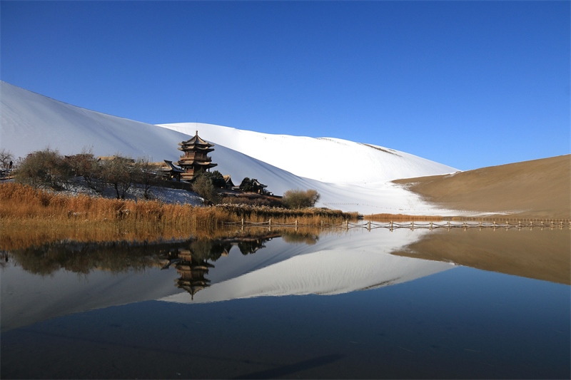 鳴沙山月牙泉景區(qū)雪景。敦煌市委宣傳部供圖，張曉亮攝