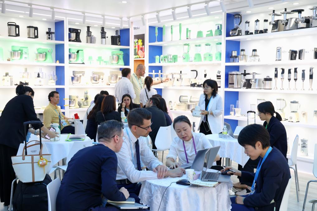 4月15日，在第137屆廣交會開幕當天，海外客商在一家電器公司的展區(qū)洽談。 新華社記者 劉大偉 攝